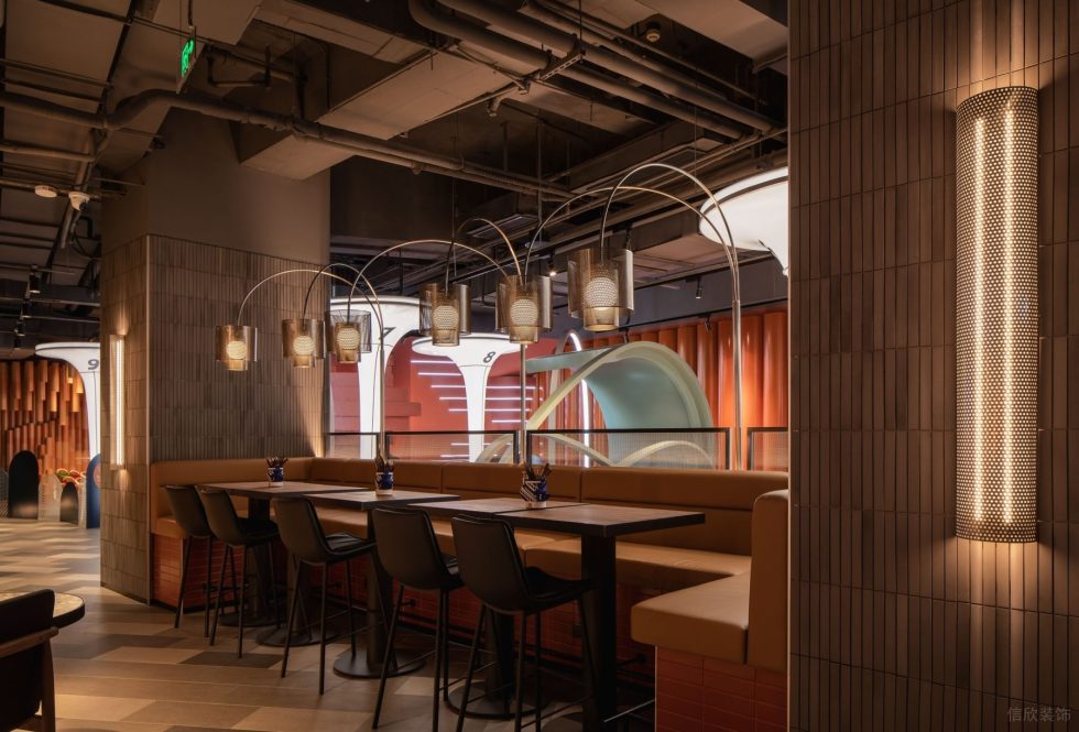 现代轻奢风高级餐厅装修设计棕黄软包配防红砖墙椅凳卡座区设计图